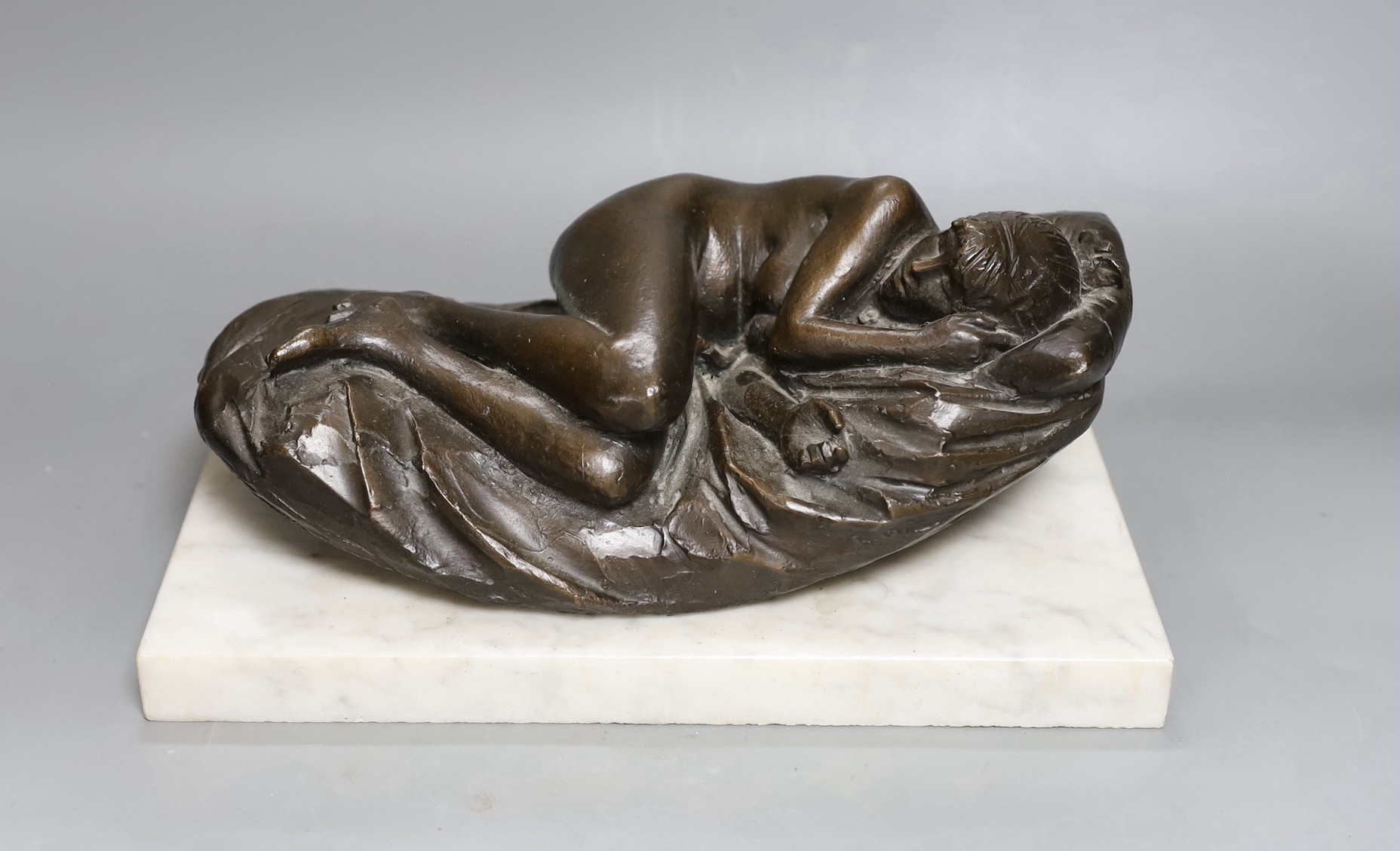 James Butler R.A. (1931-2022) A bronze reclining nude, 'Butler, 77'on a white marble plinth, total length 30.5 cm